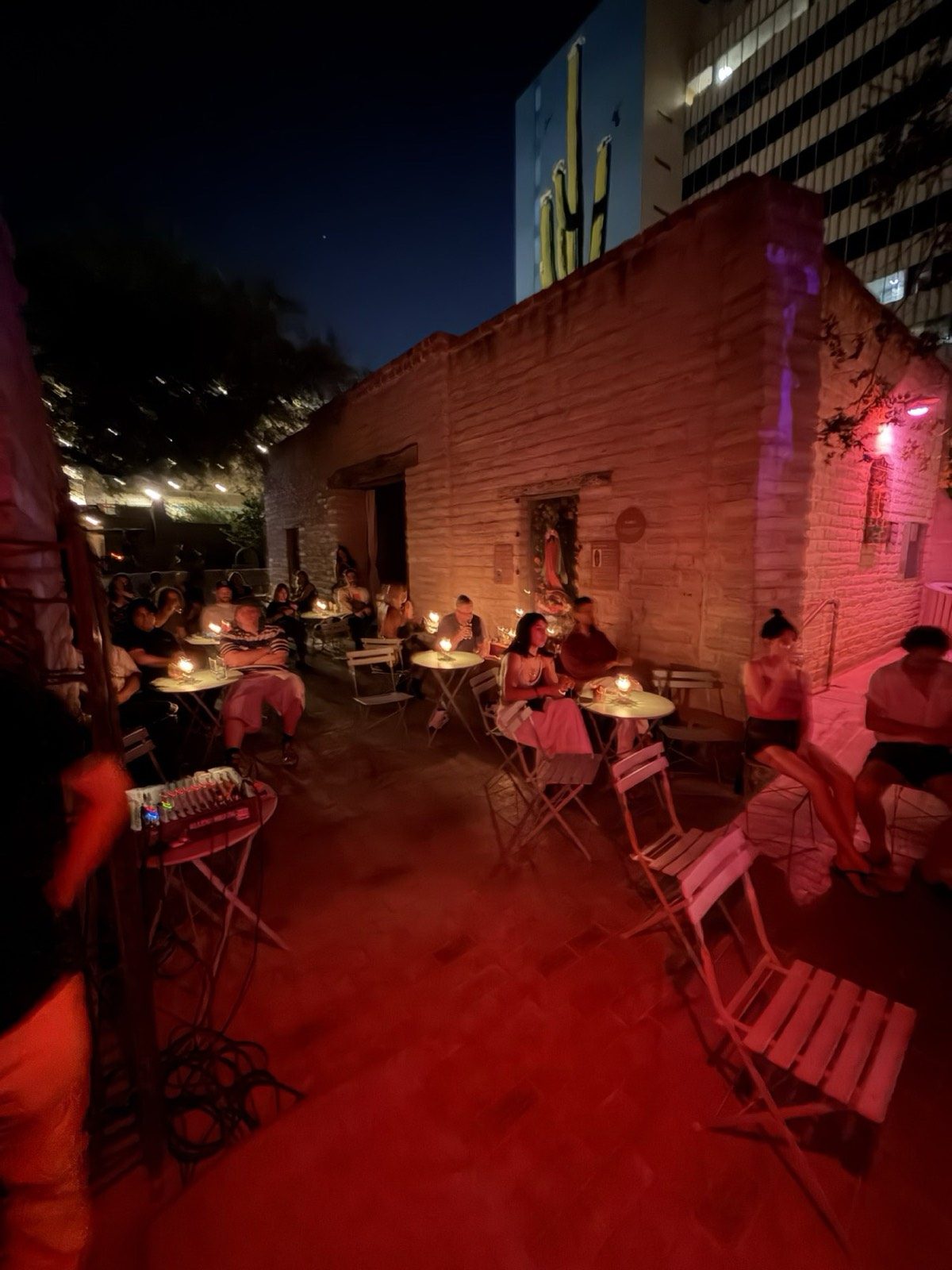 Warm red candlelit patio tables at night