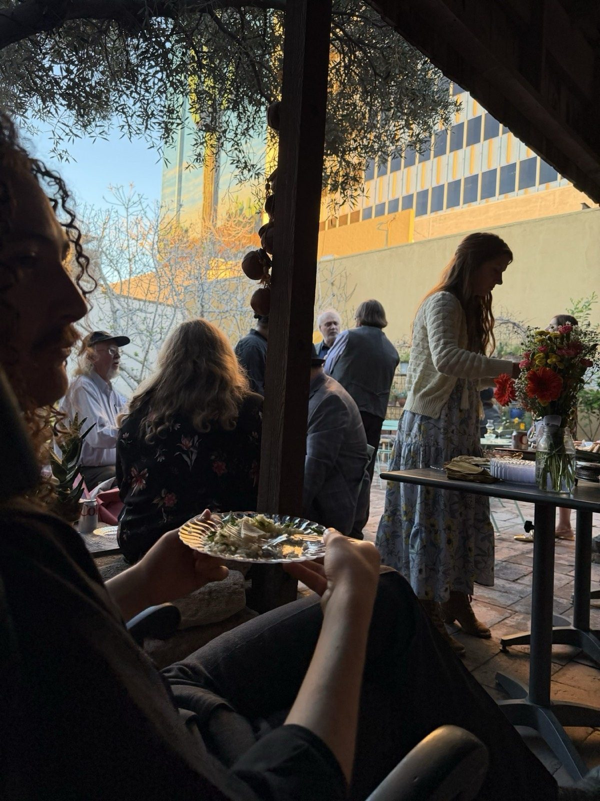 A golden-hour patio gathering with the downtown skyline behind