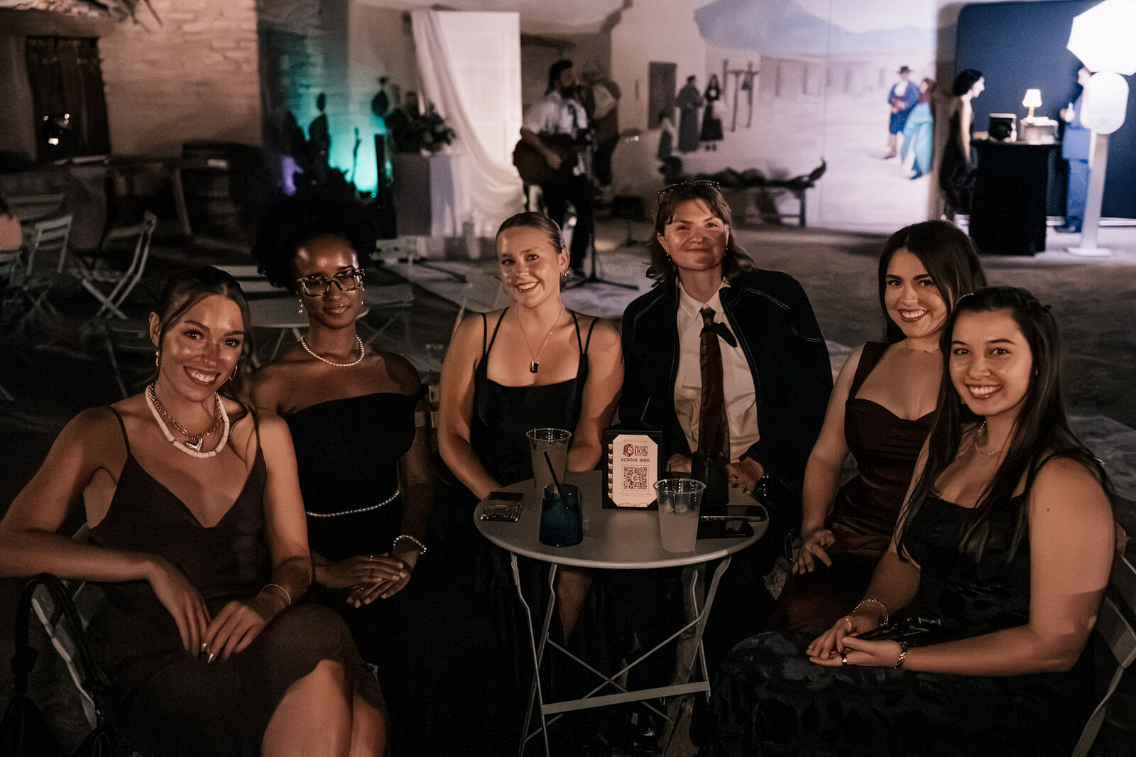 Friends gathered around a cocktail table at the reception