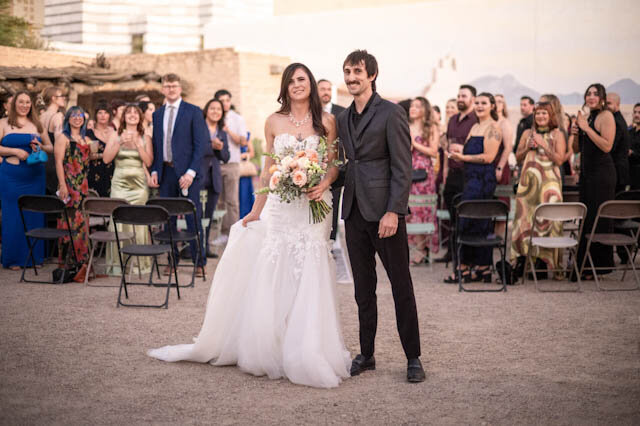 The couple walking back down the aisle together