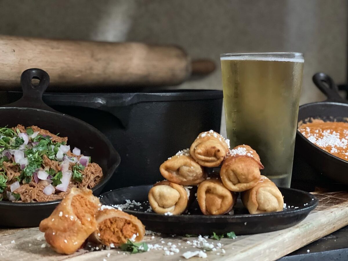Carne seca and smoky appetizers on cast iron with a cold beer, from El Charro